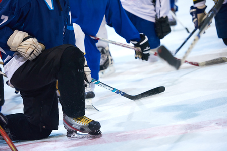 ice hockey players team group meeting with trainer  in sport arena indoorsの写真素材