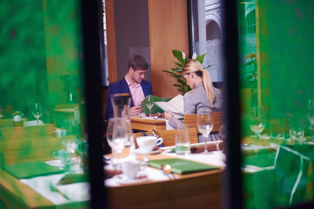 business people meeting in modern restaurant, romantic couple having dinner and take drink after workの写真素材
