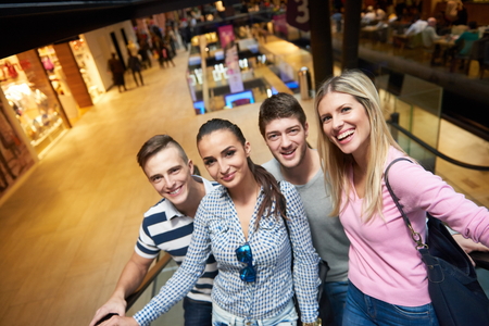 group of happy  friends in shopping mall have funの写真素材