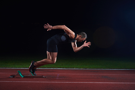 Sprinter leaving starting blocks on the running track. Explosive start.の写真素材