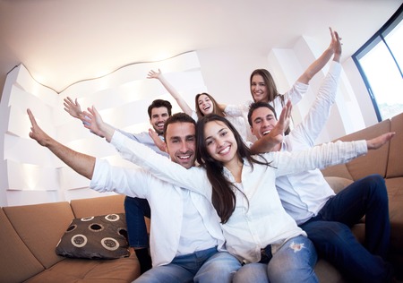 group of friends taking selfie photo with tablet at modern home indoorsの写真素材