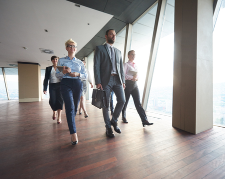 business team, businesspeople  group walking at modern bright office interiorの写真素材