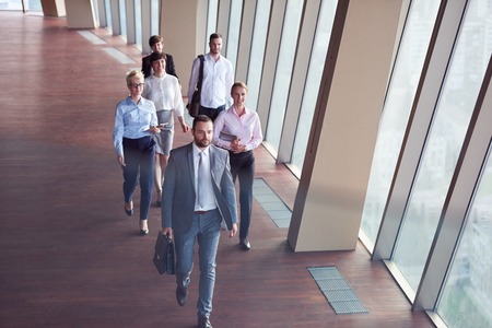 business team, businesspeople  group walking at modern bright office interiorの写真素材