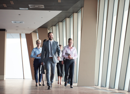 business team, businesspeople  group walking at modern bright office interiorの写真素材