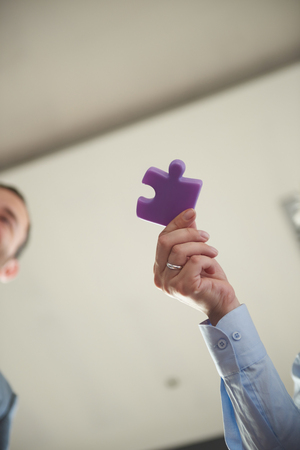 business people group assembling jigsaw puzzle and represent team support and help concept, top view perspective at modern bright office interiorの写真素材