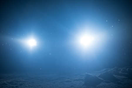 winter night scene, falling snow background snowflakes in blur over dark backgroundの写真素材