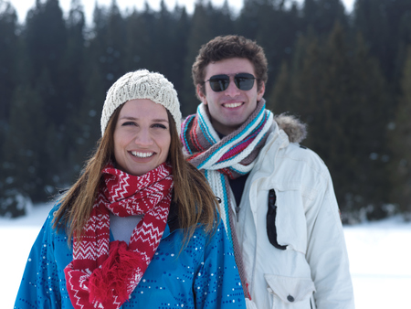 portrait of happy young romantic tourist  couple outdoor in nature at winter vacationの写真素材