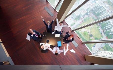 top view of  business people group on meeting throwing documents in airの写真素材