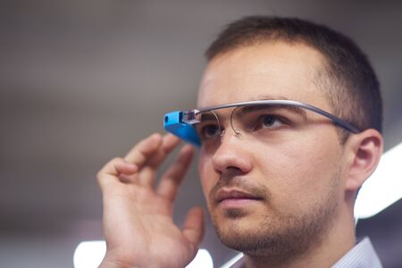 young man using virtual reality gadget computer technology glasses