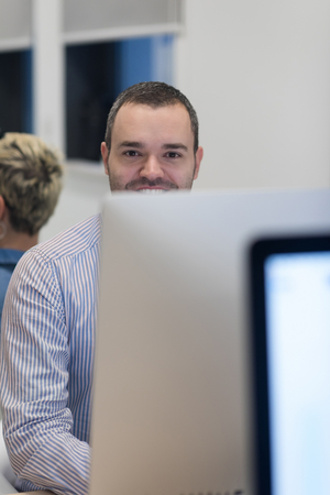 startup business, software developer working on desktop  computer at modern officeの写真素材