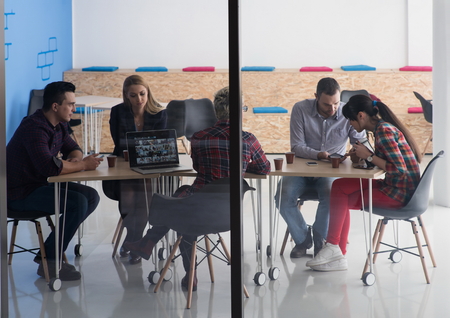 startup business team on meeting in modern bright office interior brainstorming, working on laptop...