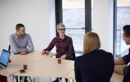 startup business team on meeting in modern bright office interior brainstorming, working on laptop...