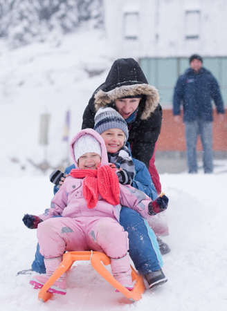 group of children having fun and play together in fresh snow on winter vacationの写真素材