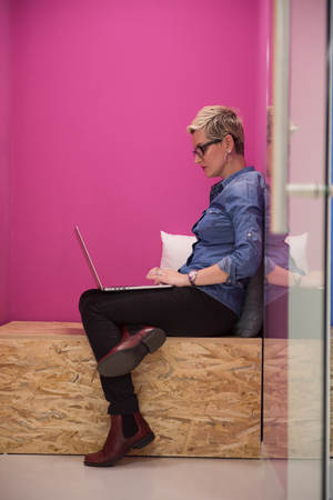 young woman in crative box working on laptop computer, startup business modern office room  interiorの写真素材
