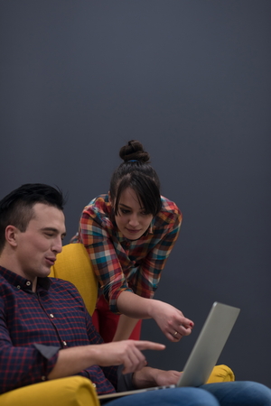 startup business team on meeting in modern bright office interior brainstorming, working on laptop and tablet computerの写真素材