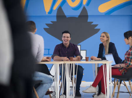 startup business team on meeting in modern bright office interior brainstorming, working on laptop and tablet computerの写真素材