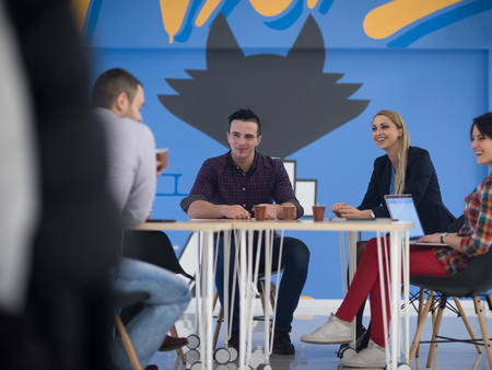 startup business team on meeting in modern bright office interior brainstorming, working on laptop...