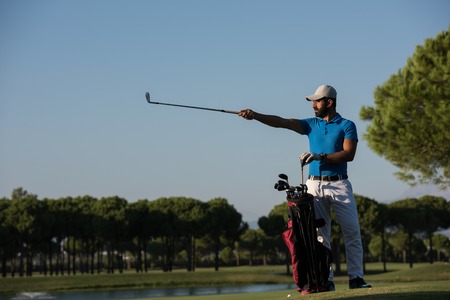 handsome middle eastern golf player portrait at course at sunny dayの写真素材