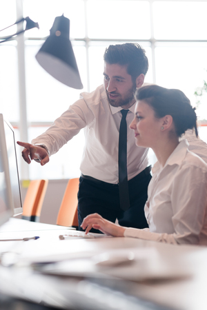 business couple working together on project at modern startup officeの写真素材
