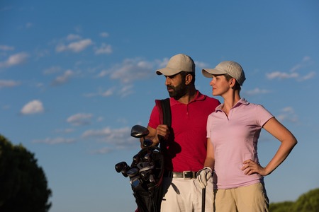 portrait of happy young  couple on golf courseの写真素材