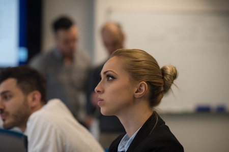 portrait of young business woman at modern startup office interior, team in meeting group in backgroundの写真素材