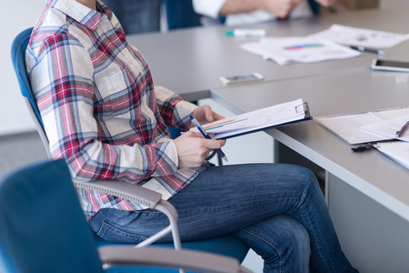 portrait of young business woman at modern startup office interior, team in meeting group in backgroundの写真素材