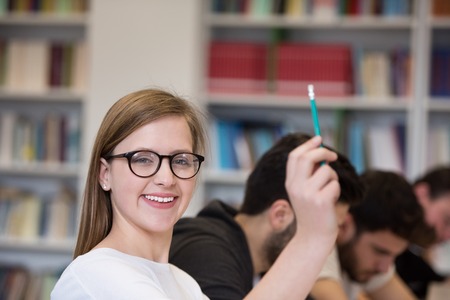 group of  smart students raise hands up in school  classroom on classの写真素材