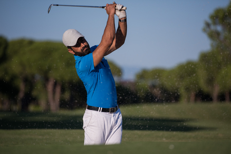 pro golf player shot ball from sand bunker at courseの写真素材