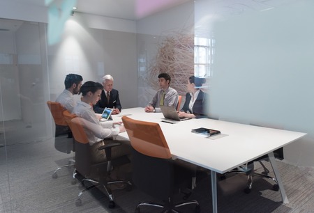 business people group brainstorming on meeting and businessman presenting ideas and projects oon laptop and tablet computerの写真素材