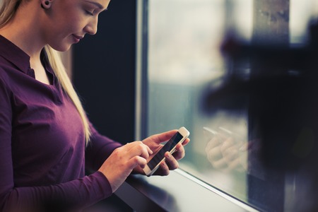 business woman at office using smart phone to check internet and type messages