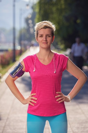 portrait of jogging woman before running  on early morning with sunrise in background