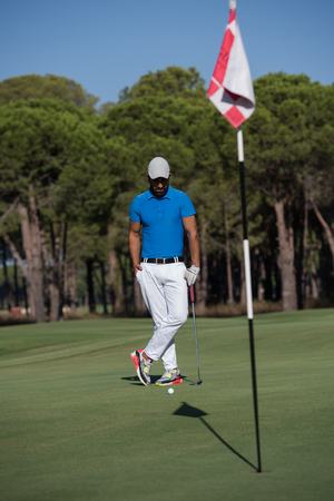 handsome middle eastern golf player portrait at course at sunny dayの写真素材