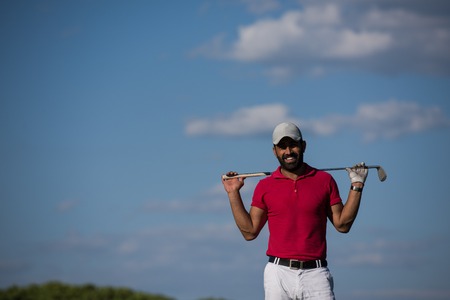 handsome middle eastern golf player portrait at course at sunny day wearing red  shirtの写真素材