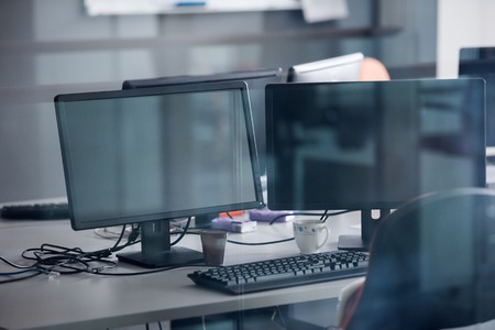 empty startup office interior with modern computers and  dual screen monitors