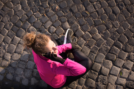 runner   woman warming up and stretching before morning joggingの写真素材