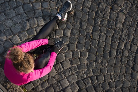 runner   woman warming up and stretching before morning joggingの写真素材