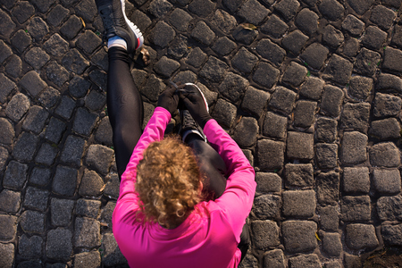 runner   woman warming up and stretching before morning joggingの写真素材
