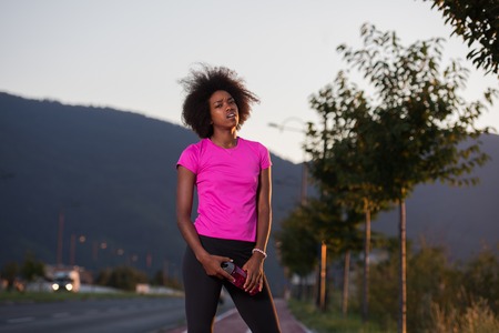 portrait of a young African American girl to run beautiful summer evening on city streets