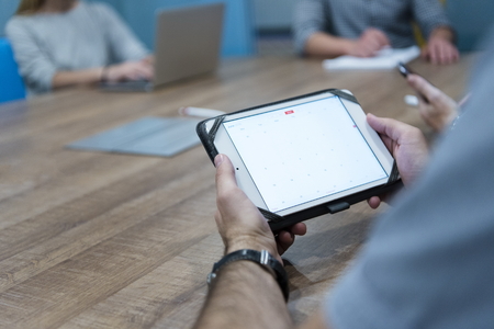 close up of businessman hands using tablet computer  on start up business meeting