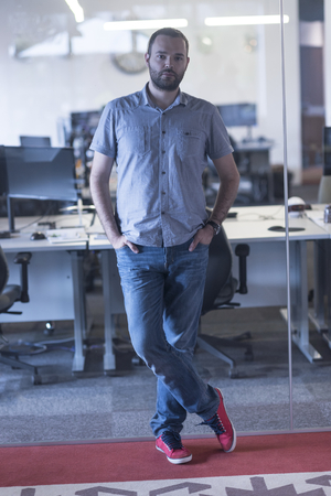 happy young business man at modern startup officeの写真素材