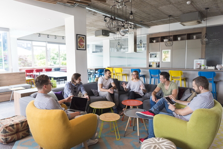 young people group in modern office have team meeting and brainstorming while working on laptop and...