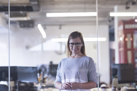 portrait of casual business woman at her modern start up business office interiorの写真素材
