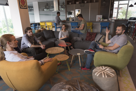 young people group in modern office have team meeting and brainstorming while working on laptop and drinking coffeeの写真素材