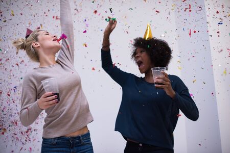 confetti party happy young people group celebrating new year eve while dancing and have fun at homeの写真素材