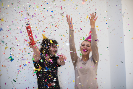 young romantic  couple in love  celebrating and blowing confetti decorationsの写真素材