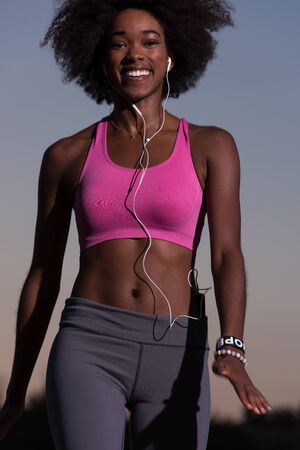 Young healthy black woman is doing stretching exercise relaxing and warm up after jogging and...