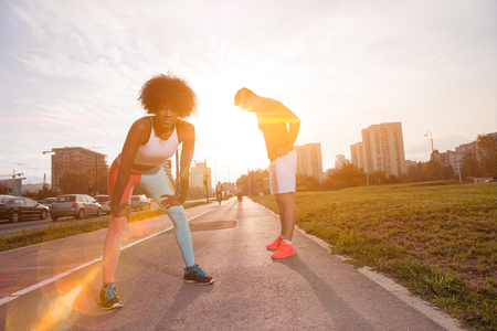 multiethnic group of young people on the jogging beautiful morning as the sun rises in the streets of the cityの写真素材