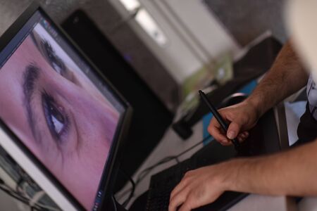Young graphic designer working on a digital tablet and a computer