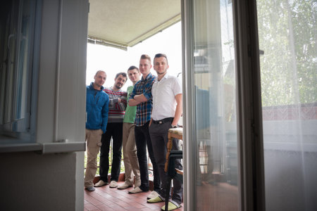 portrait of a group of men standing on the balcony