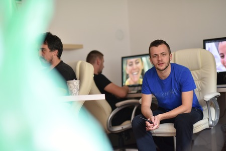 a group of young graphic designers working on a digital tablet and a computerの写真素材